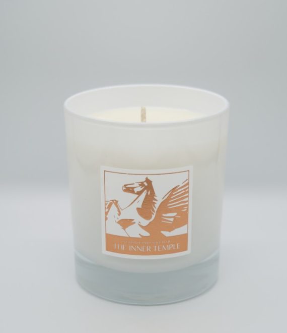 White candle with a bronze Inner Temple sticker